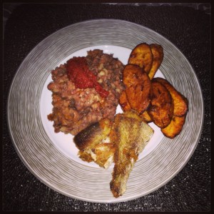 Boiled beans, tomato stew with palm oil, fried plantain and fried fish.